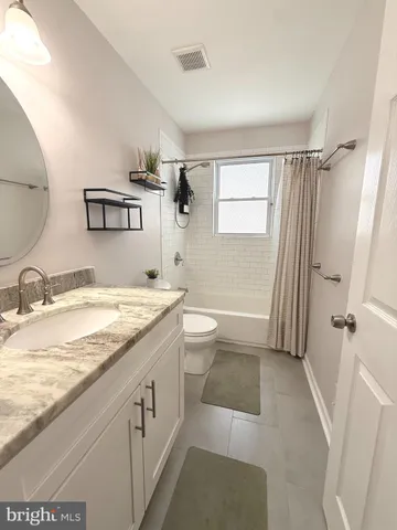a bathroom with a toilet a sink and bathtub