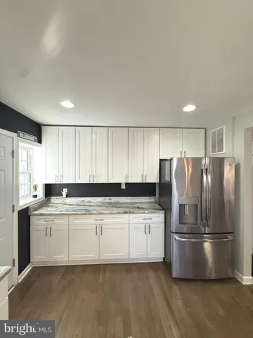 a kitchen with stainless steel appliances kitchen island granite countertop a refrigerator stove microwave and sink