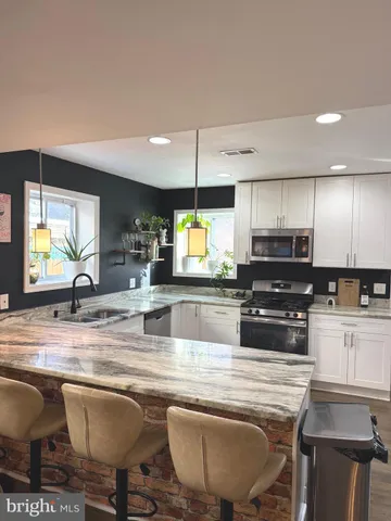 a front view of a building with trees