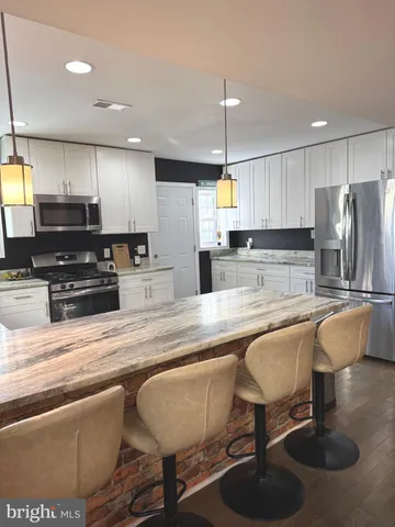 a street sign on a wall next to road