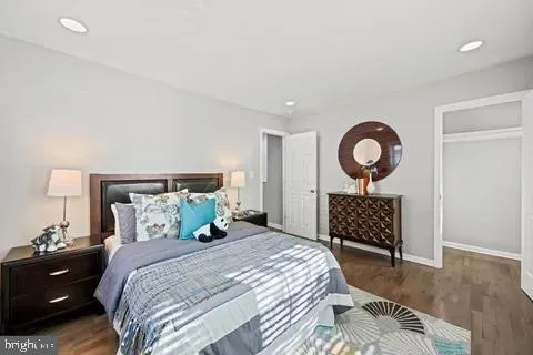 a bedroom with a bed and a night stand