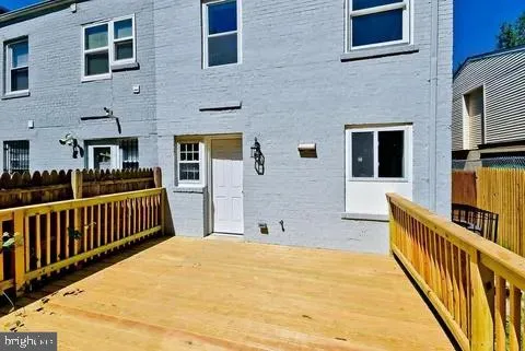 a room with stainless steel appliances lots of white furniture