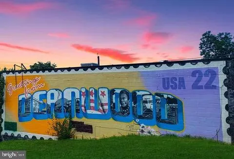 a view of a wooden deck with chairs and a yard