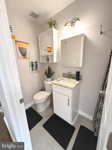 a bathroom with a sink toilet a mirror and vanity