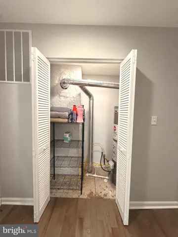 a bathroom with a granite countertop sink a toilet and shower