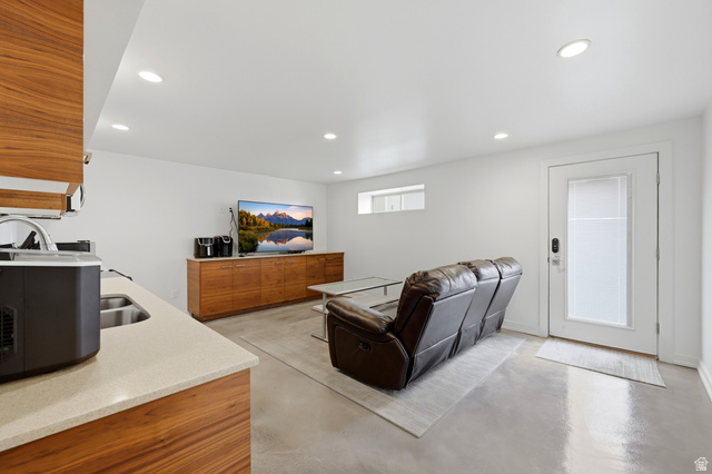 1389 Millbrook Way Bountiful, UT 84010 - Photo 46 of 74 Spacious living area featuring polished concrete flooring, recessed lighting, and a built-in wood-finish media console