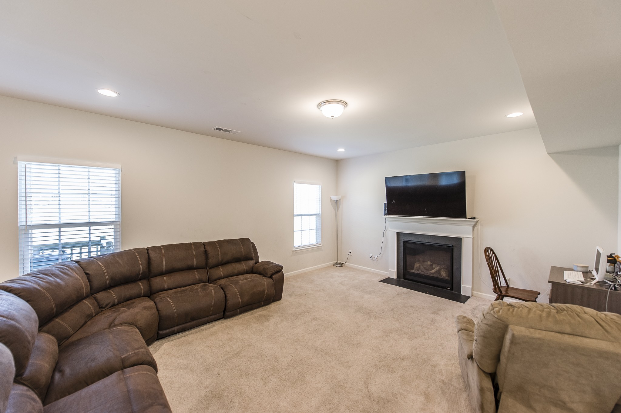 140 Hackney Lane Gallatin, TN 37066 - Photo 14 of 57 a living room with furniture a flat screen tv and a fireplace