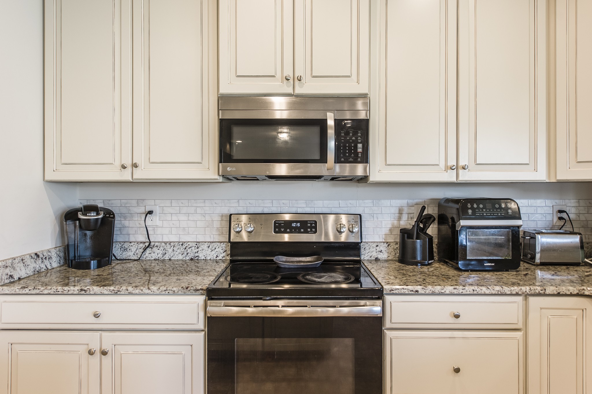 140 Hackney Lane Gallatin, TN 37066 - Photo 22 of 57 a kitchen with granite countertop white cabinets and stainless steel appliances