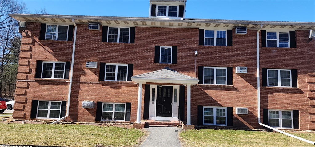 74 Leonard Road, Unit 74 Boxborough, MA 01719 - Photo 1 of 11 front view of a house with a yard