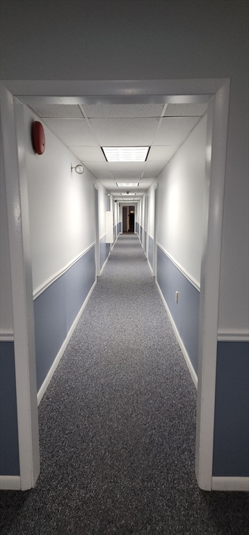 74 Leonard Road, Unit 74 Boxborough, MA 01719 - Photo 8 of 11 a view of empty room with wooden floor