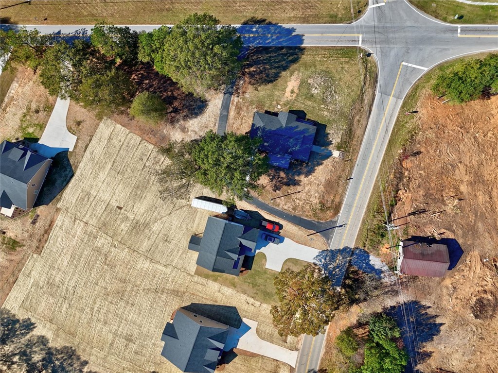 801 Cherokee Road Pelzer, SC 29669 - Photo 38 of 45 An aerial view showcases houses nestled amidst nature, connected by paved roads and natural surroundings.