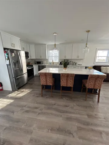 a view of kitchen with stainless steel appliances granite countertop cabinets and a counter top space