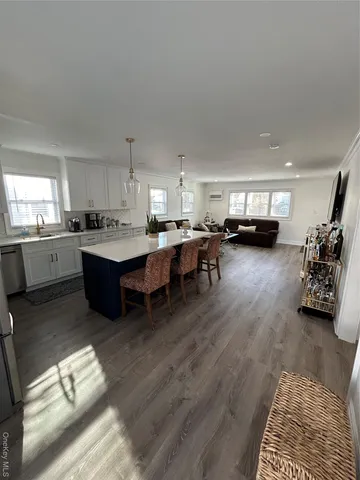 a living room with furniture and a kitchen
