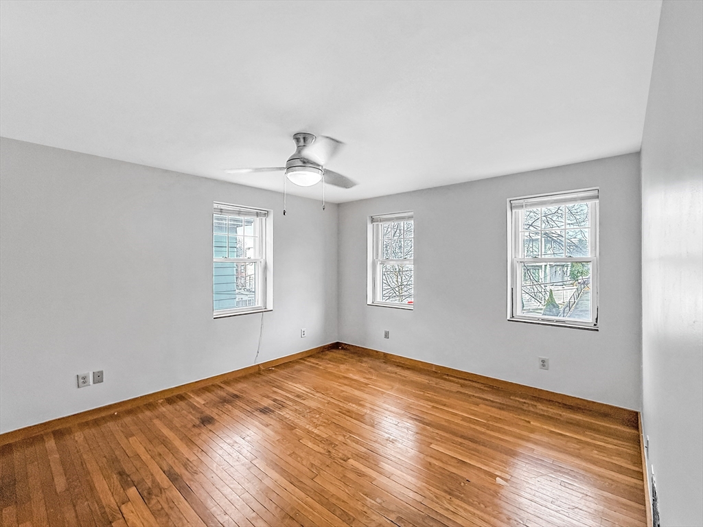 17 Suffolk Street, Unit 1 Chelsea, MA 02150 - Photo 2 of 3 a view of empty room with wooden floor and fan