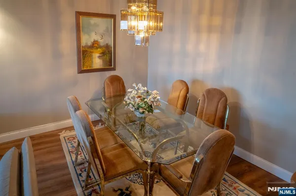 a dining room with furniture and chandelier