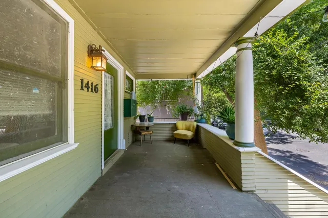 a view of a porch with furniture and floor to ceiling window