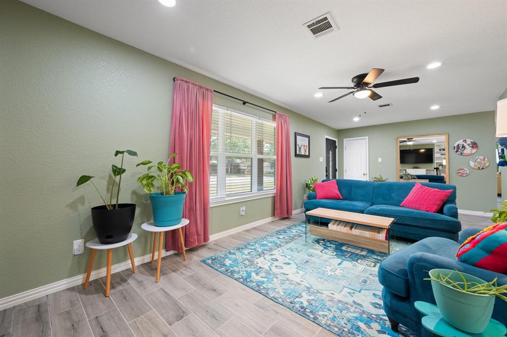 806 Colonial Drive Cleburne, TX 76033 - Photo 7 of 27 a living room with furniture and a potted plant