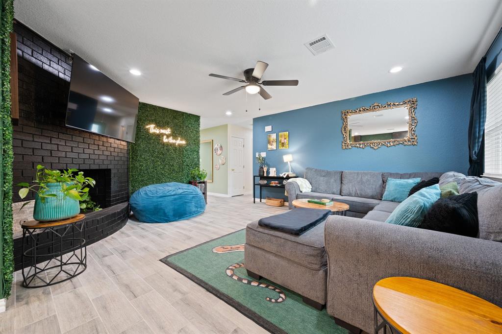 806 Colonial Drive Cleburne, TX 76033 - Photo 9 of 27 a living room with furniture and a wooden floor