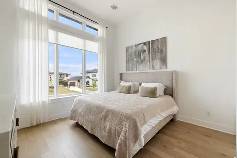 a bedroom with a large bed and a window
