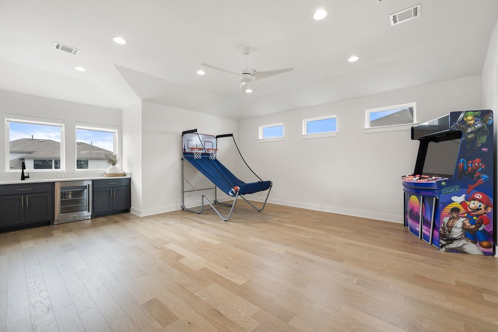 802 Geiger Path Austin, TX 78738 - Photo 14 of 40 Spacious game room with beverage cooler and bar with sink