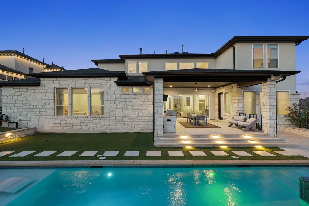 802 Geiger Path Austin, TX 78738 - Photo 16 of 40 Back yard of your dreams! Back of house with a covered patio, a pool and spa and putting green. The entertainers paradise!