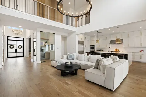 a living room with furniture and a chandelier