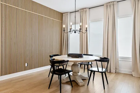 a view of a room with furniture and wooden floor