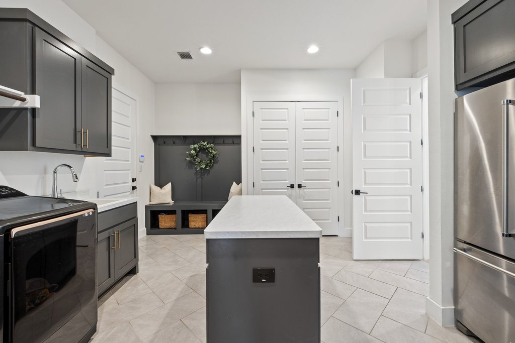 802 Geiger Path Austin, TX 78738 - Photo 27 of 40 Dedicated laundry/Mud room with a center island, and recessed lighting.