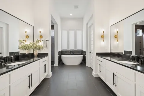 a large white kitchen with a large window and stainless steel appliances