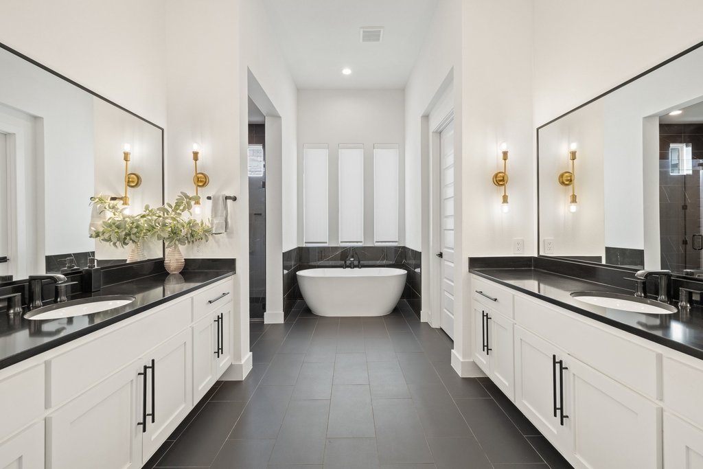802 Geiger Path Austin, TX 78738 - Photo 7 of 40 Primary bathroom with two vanities, a freestanding tub, and seperate stand up shower.