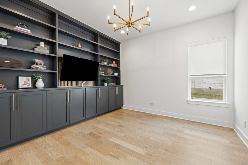 802 Geiger Path Austin, TX 78738 - Photo 8 of 40 Home office with built in shelving and cabinetry for storage and display.