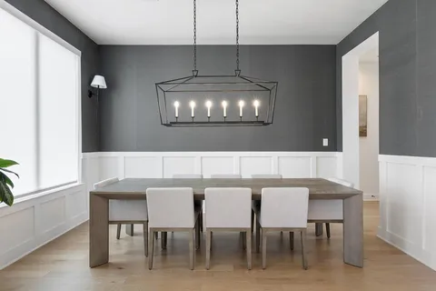 a view of a dining room with furniture and chandelier