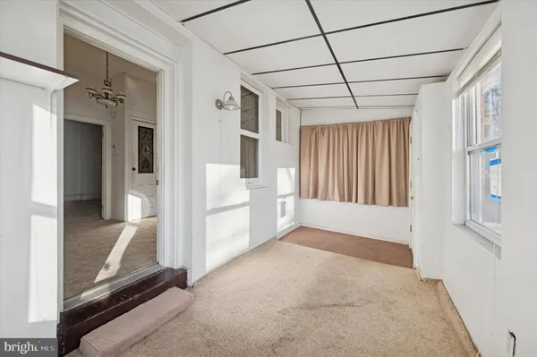 a view of an empty room with a fireplace