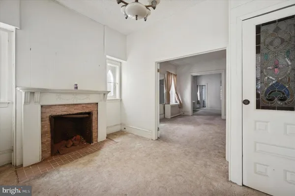 a view of an empty room with a kitchen
