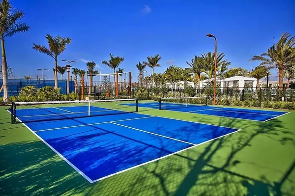 an aerial view of a tennis ground and a yard