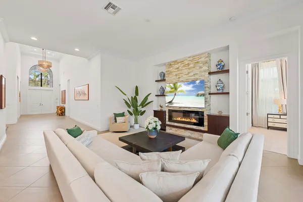 a living room with kitchen island furniture and a chandelier