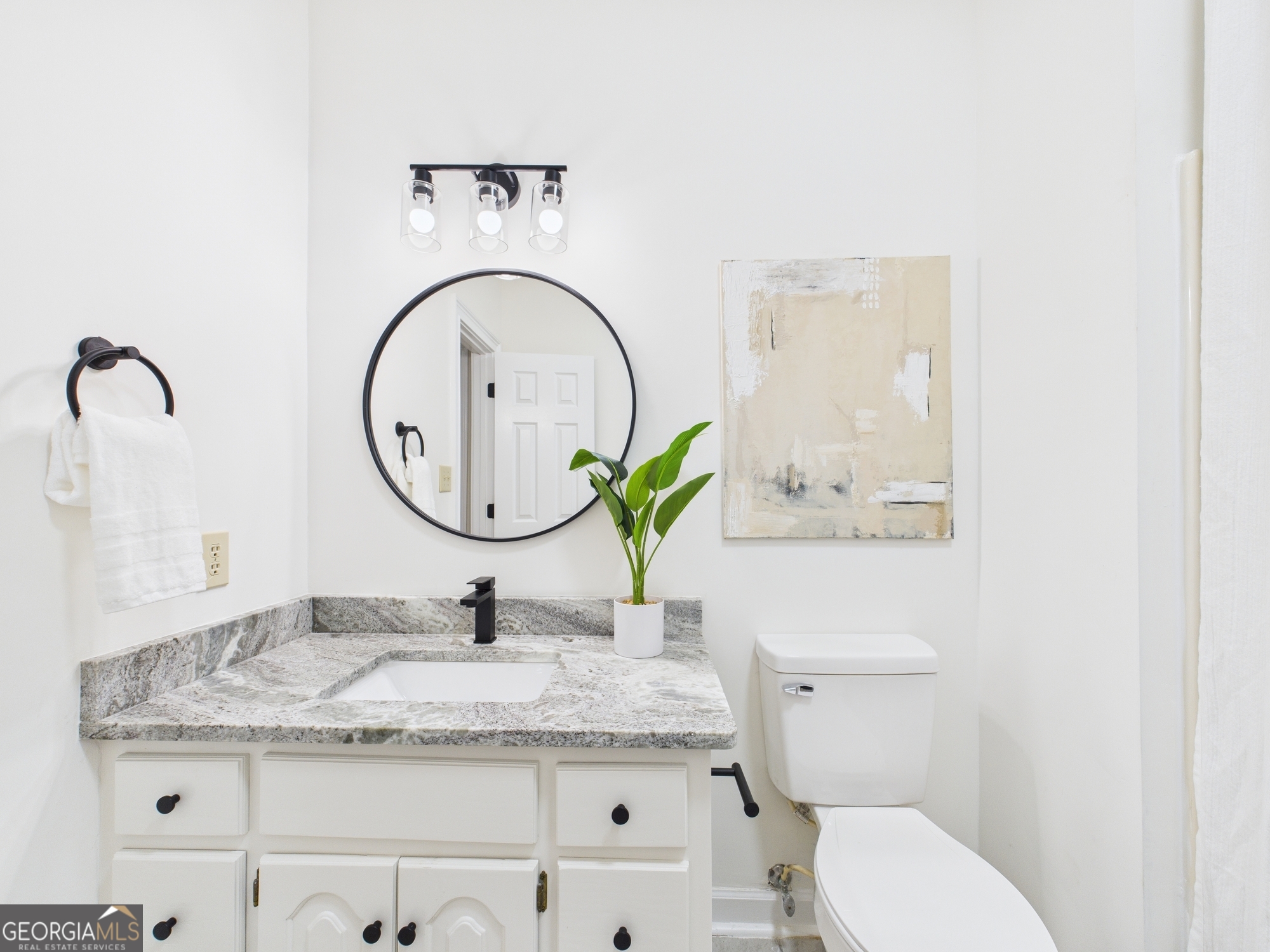607 Chastain Place Macon, GA 31210 - Photo 28 of 63 a bathroom with a granite countertop toilet a sink and a mirror