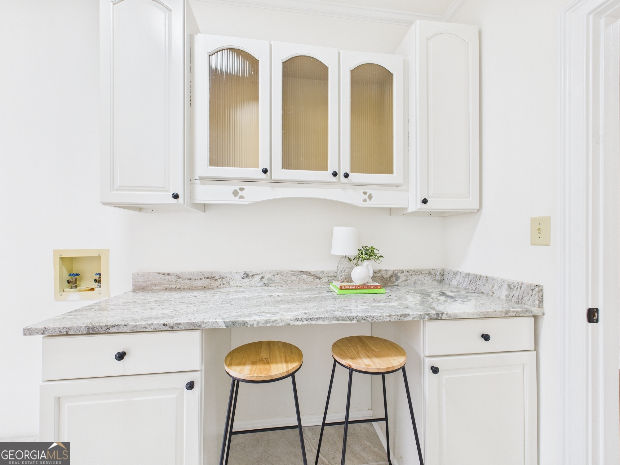 607 Chastain Place Macon, GA 31210 - Photo 36 of 63 a kitchen with stainless steel appliances granite countertop a sink a stove and white cabinets with wooden floor