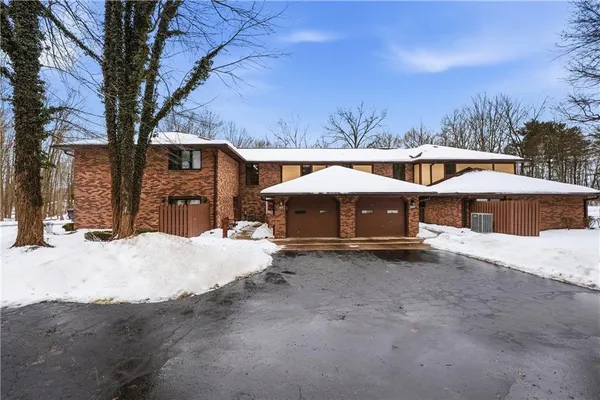 a wooden bench sitting in front of a building