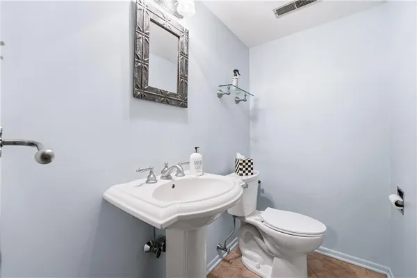 a bathroom with a sink toilet and mirror