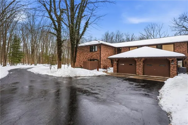 a view of a house with snow on the road