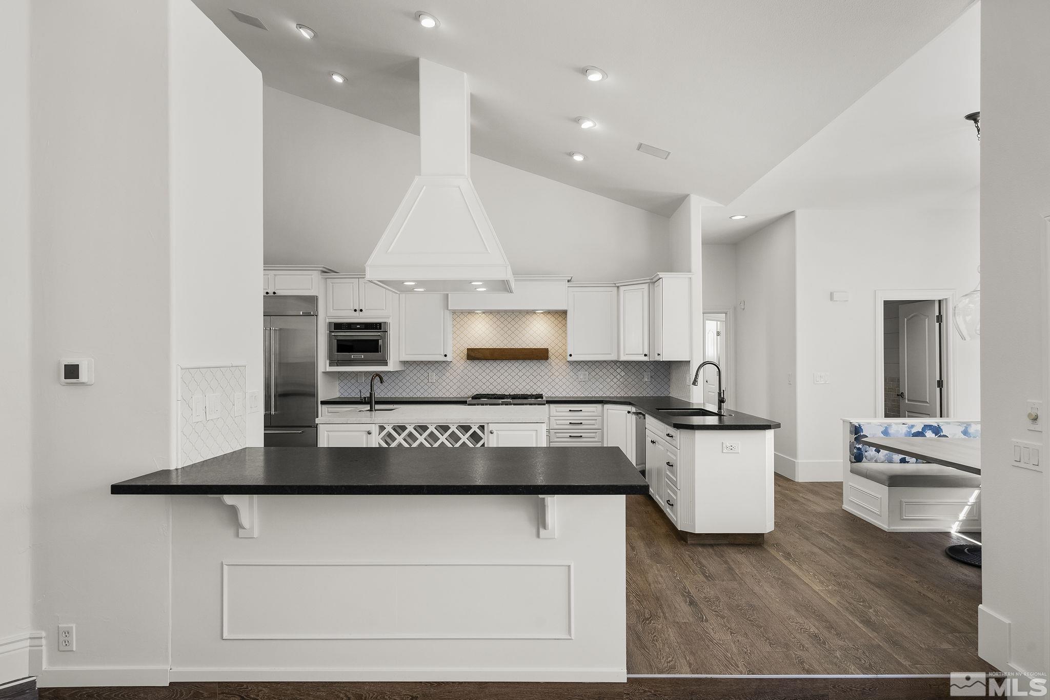 4900 Gallup Road Reno, NV 89511 - Photo 7 of 38 a kitchen with kitchen island stainless steel appliances a sink and cabinets