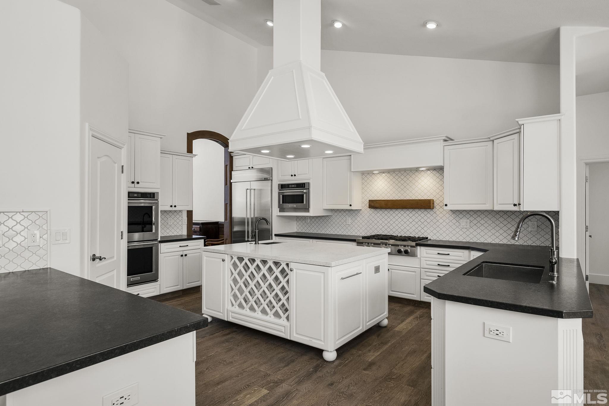 4900 Gallup Road Reno, NV 89511 - Photo 9 of 38 a kitchen with a stove a sink and a refrigerator