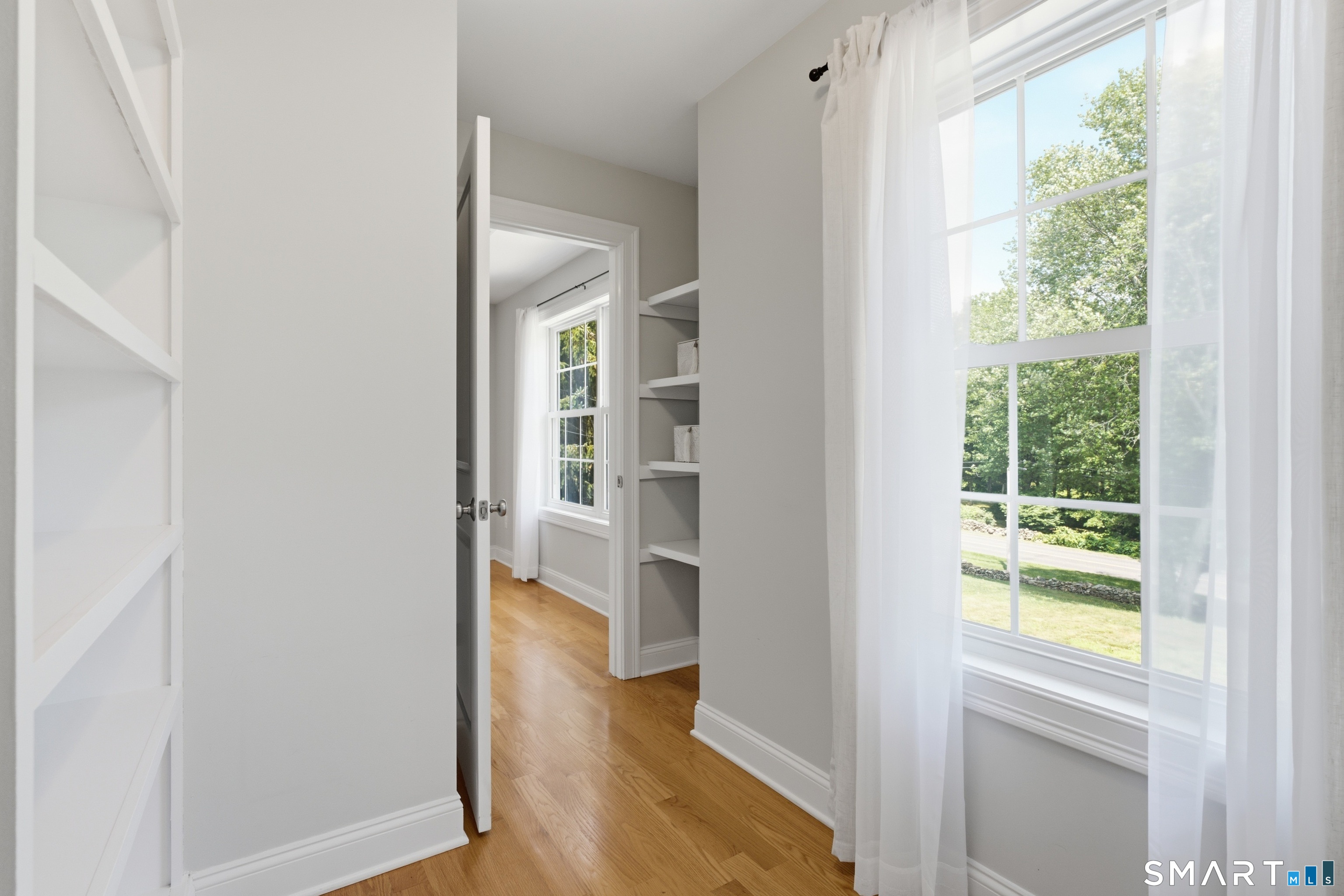 838 Little Meadow Road Guilford, CT 06437 - Photo 18 of 40 The walk in closet for the primary bedroom. If you have never had a window in your closet, you do not know what you are missing!
