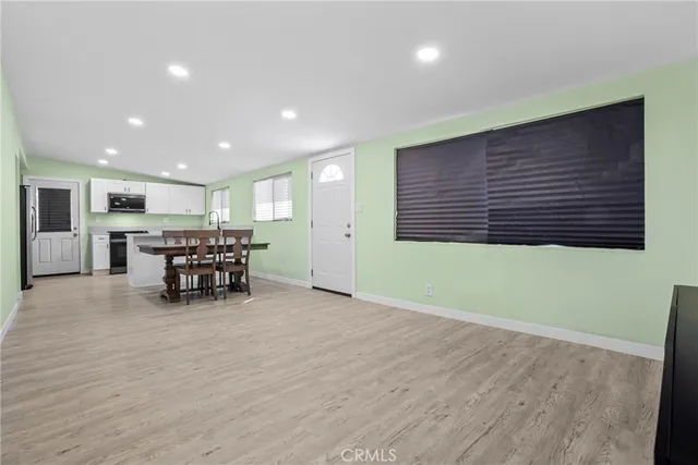 a big room with wooden table and chairs