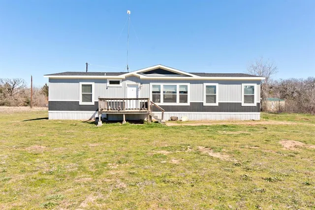 a front view of a house with a big yard
