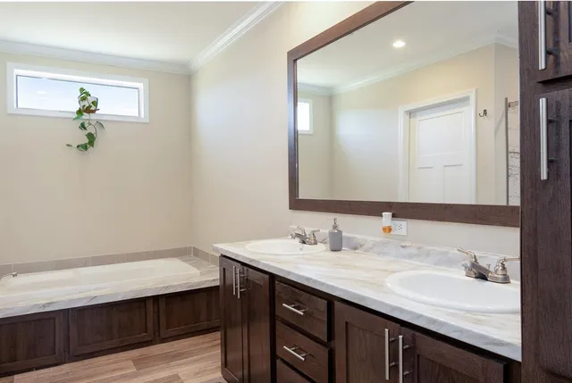 a bathroom with a sink vanity granite and a mirror