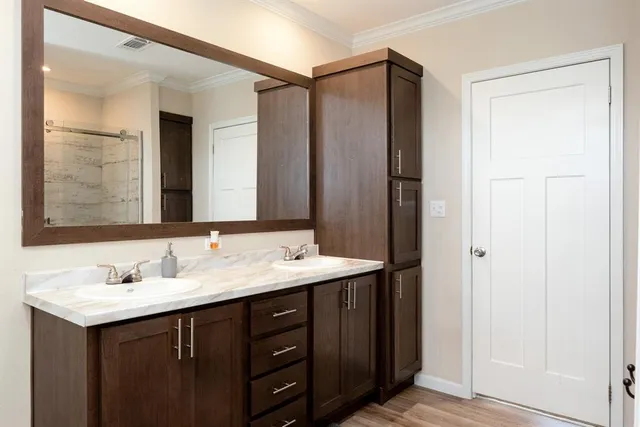 a bathroom with a double vanity sink and mirror