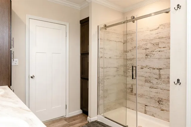 a bathroom with a glass shower door
