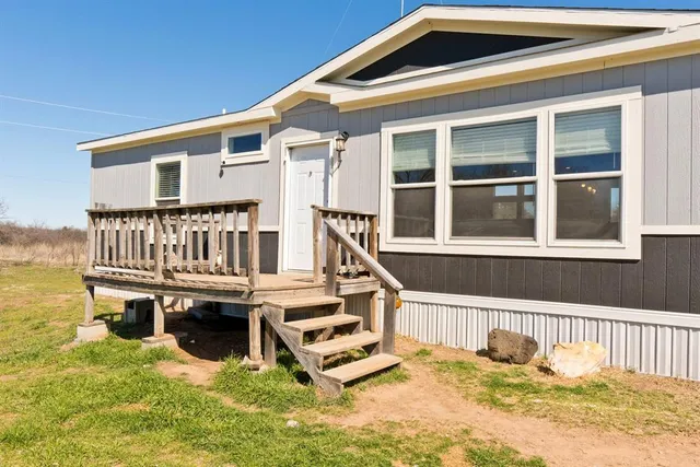 a view of a house with pool and deck